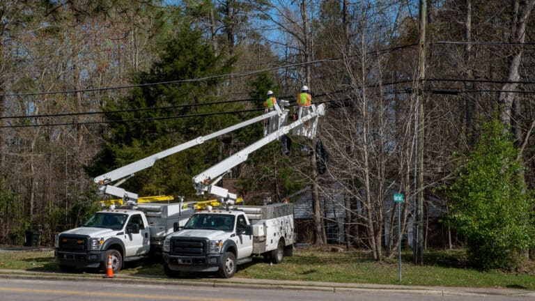 Southeastern Utility Services crew operating bucket trucks on power lines — reliable utility services contractor at work