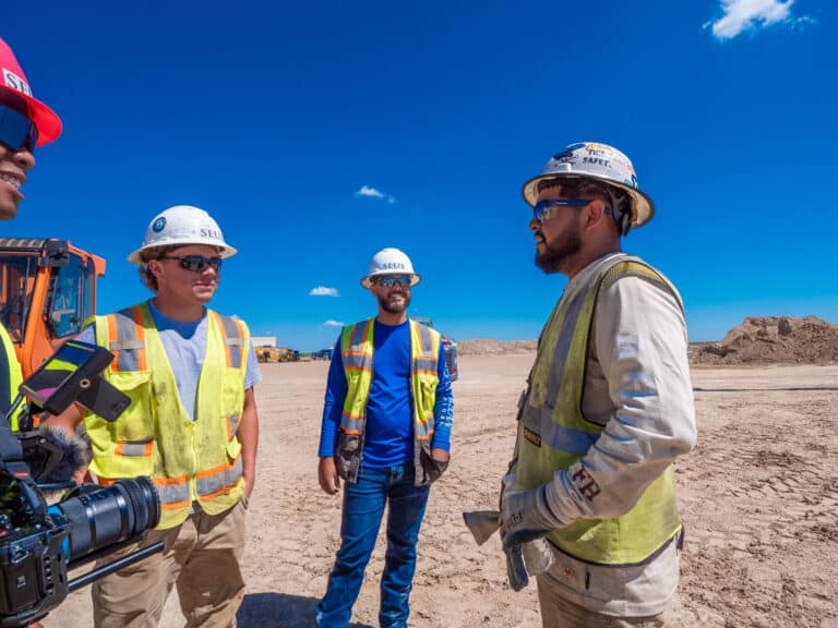 Logan Busch and crew member reviewing substation construction estimate on job site